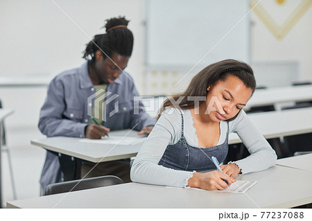 Students writing in classroom Students writing in classroom 77237088