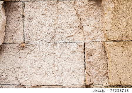 Cracks on the white wall blocks. The destruction of the wall. Background texture Cracks on the white wall blocks. The destruction of the wall. Background texture 77238718