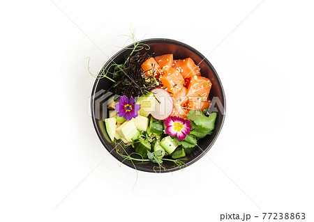 Poke with salmon in a bowl. Ingredients fresh salmon, avocado, cucumber, rice, Tamarind sauce, mango 77238863