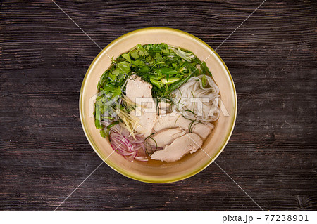 meat chicken broth with rice noodles, ginger and chopped greens 77238901
