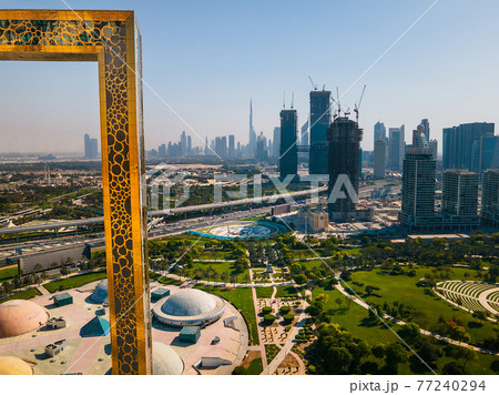 Dubai skyline seen through Dubai Frame building with Zabeel park and Dubai skyline aerial cityscape view of the Emirate 77240294