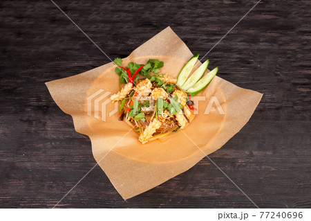 glass noodle salad with shrimp, vegetables and greens sprinkled with sesame 77240696