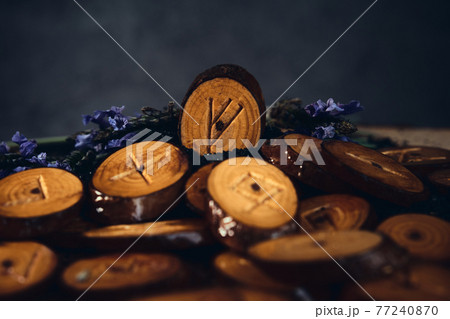homemade wooden runes on a dark background 77240870
