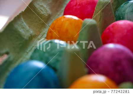 There are Easter eggs in a cardboard box. Holiday symbol. 77242281