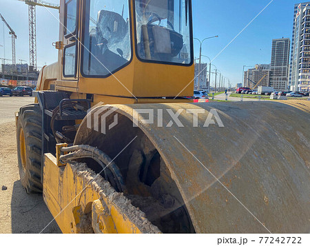 Road works in the city. Working on special equipment cut off the old asphalt on a Sunny summer day 77242722