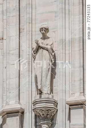Decorative Religious figure at facade of the Cathedral of Milano, Milan, Italy 77243135
