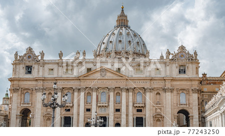 Dramatic view over Saint Peter Basilica in Vatican city, in the center of Rome, Italy, with heavy clouds. Dramatic view over Saint Peter Basilica in Vatican city, in the center of Rome, Italy, with heavy clouds. 77243250