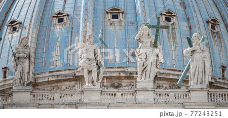 Statues of saints at Saint Peter Basilica dome in Vatican city, in the center of Rome, Italy, closeup, details. 77243251