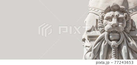 Bas-relief of an old sculpture of lion with ring as a gatekeeper in historical downtown of Dresden, with copy space. Concept of art and historical heritage. 77243653
