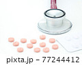 A coin stack growth increase with a stethoscope. Business health care concept. 77244412