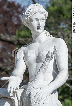 Old statue of a sensual naked Renaissance Era woman in the park of Potsdam, Germany, details, closeup 77244526
