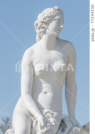 Old statue of a sensual naked Renaissance Era woman in the park of Potsdam, Germany, details, closeup 77244530