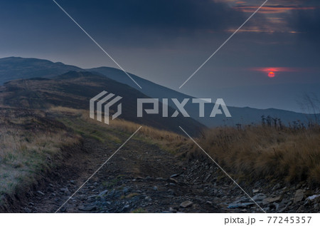 Night in the mountains. Sunset. The sky is the color of blood. Outdoor. Night in the mountains. Sunset. The sky is the color of blood. Outdoor. 77245357