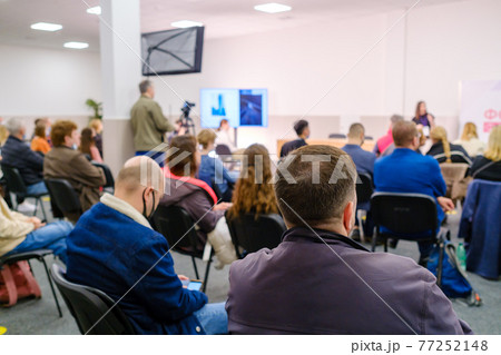Business speaker doing presentation to audience Business speaker doing presentation to audience 77252148