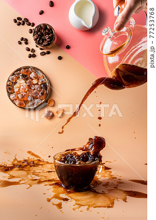 pouring coffee in a cup pouring coffee in a cup 77253768