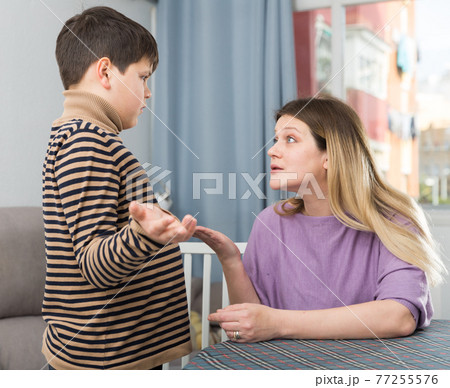 Offended son and unhappy mom having quarrel in home Offended son and unhappy mom having quarrel in home 77255576