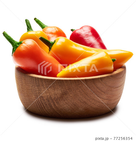 Wooden bowl full of Chili or sweet peppers isolated on white background 77256354