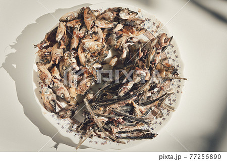 Fish heads and bones left after eating on a plate. Fish heads and bones left after eating on a plate. 77256890