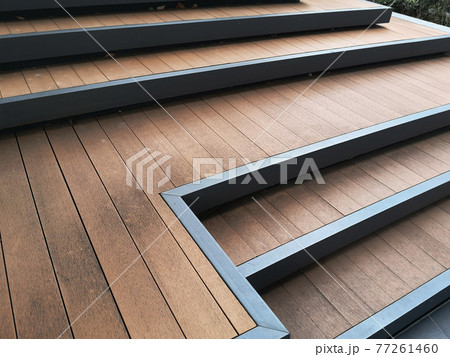 Modern outdoor wooden benches is stairway in the garden. 77261460