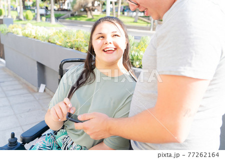 disabled young woman in wheelchair 77262164