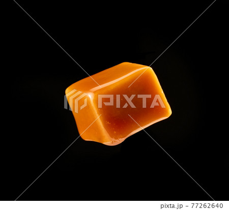 caramel candy on black background 77262640
