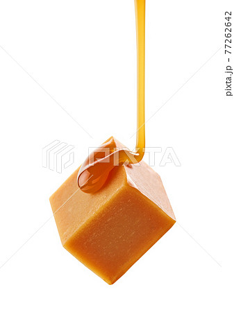 caramel sauce flowing on flying caramel candy caramel sauce flowing on flying caramel candy 77262642