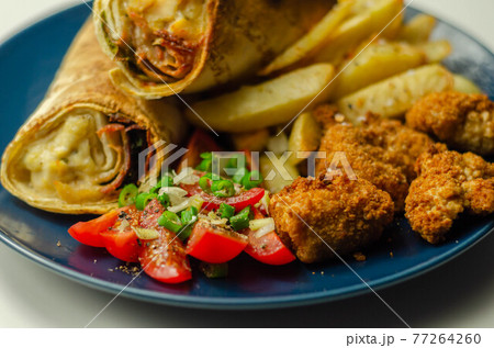 Tortilla wrap with chicken and beechwood smoked bacon served with chicken nuggets and chips 77264260