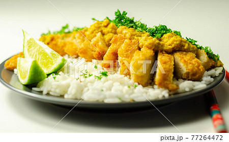 Crispy chicken perked up with an aromatic katsu curry sauce and fragrant fluffy rice 77264472