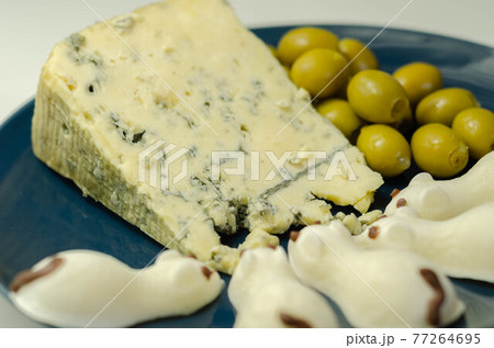 Full fat soft blue veined cheese with olives and snacks in the shape of mice 77264695
