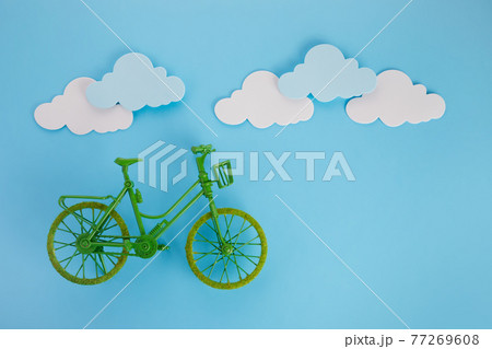 3rd June World Bicycle Day. Green bicycle on blue background. Environment preserve. 3rd June World Bicycle Day. Green bicycle on blue background. Environment preserve. 77269608