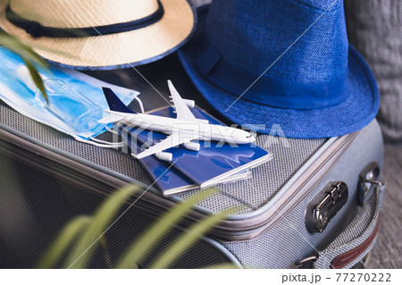 Travelling during corona virus epidemic. Passports and protective masks respirator with hand sanitizer. Travel concept. 77270222