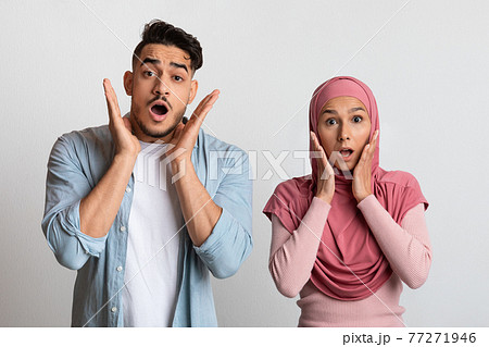 Portrait Of Frightened Young Muslim Couple Looking At Camera With Shock Portrait Of Frightened Young Muslim Couple Looking At Camera With Shock 77271946