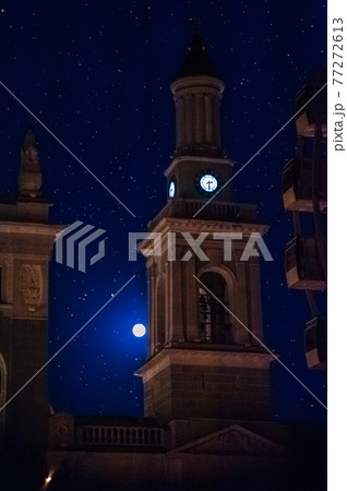 The bell tower of the Church of St. Catherine (Greek Monastery) at night in the light of the moon and stars. Contract Square, Kyiv Ukraine The bell tower of the Church of St. Catherine (Greek Monastery) at night in the light of the moon and stars. Contract Square, Kyiv Ukraine 77272613