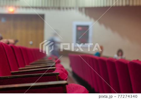 Shabby armrests of old concert hall chairs. 77274340