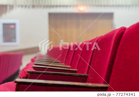 Red chairs of the concert hall. 77274341