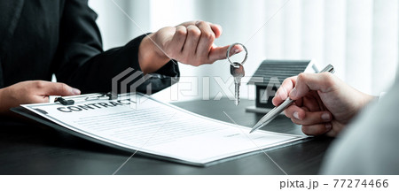 Estate agent are presenting home loan and sending keys to client after signing contract to rental house Insurance with approved property form Estate agent are presenting home loan and sending keys to client after signing contract to rental house Insurance with approved property form 77274466