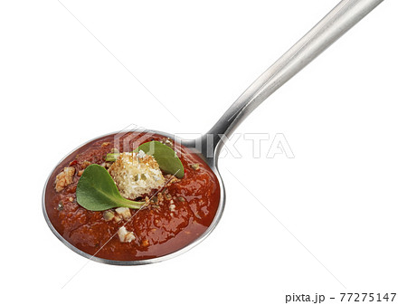 Spoon with tomato soup isolated on white background Spoon with tomato soup isolated on white background 77275147