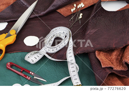A piece of leather with scissors, needles, chalk, 77276620