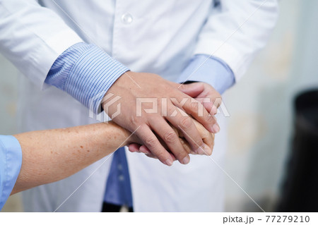 Doctor holding touching hands Asian senior or elderly old lady woman patient with love, care, helping, encourage and empathy at nursing hospital ward Doctor holding touching hands Asian senior or elderly old lady woman patient with love, care, helping, encourage and empathy at nursing hospital ward 77279210