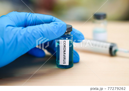 Novel Coronavirus (2019-nCoV) vaccine development medical with syringe for doctor use to treat pneumonia illness patients at Wuhan, China. 77279262