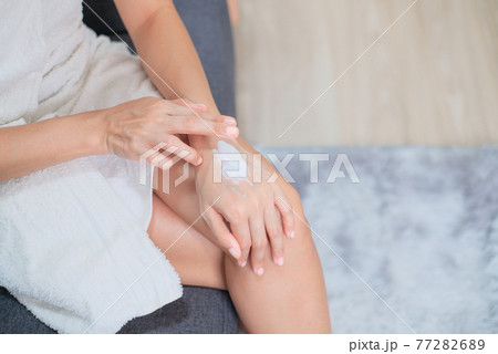 Woman applying natural cream, Woman moisturizing her hand with cosmetic cream, Spa and Manicure concept. Woman applying natural cream, Woman moisturizing her hand with cosmetic cream, Spa and Manicure concept. 77282689