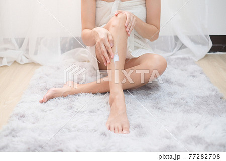 Woman applying natural cream, Woman moisturizing her leg with cosmetic cream with copy space. Woman applying natural cream, Woman moisturizing her leg with cosmetic cream with copy space. 77282708