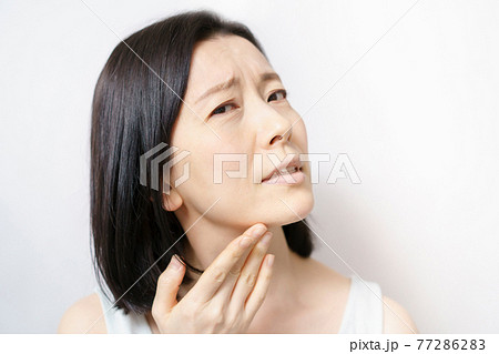 肌のトラブルに悩む中年女性 77286283