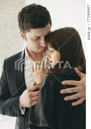 Portrait of young couple in love posing at studio 77289407