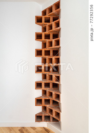 Creative interior corner of brown bricks in the apartment. Brickwork at white wall. Home design and decoration. Creative interior corner of brown bricks in the apartment. Brickwork at white wall. Home design and decoration. 77292356