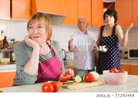Family scolding woman in kitchen Family scolding woman in kitchen 77292468