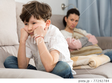 Displeased boy after discord with mother 77292784