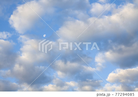 Blue summer sky white cumulus clouds and moon 77294085