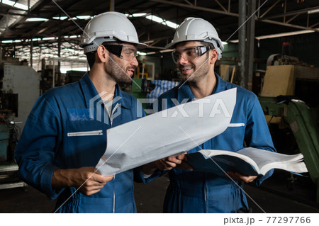 Group of skillful factory workers using machine equipment in workshop Group of skillful factory workers using machine equipment in workshop 77297766