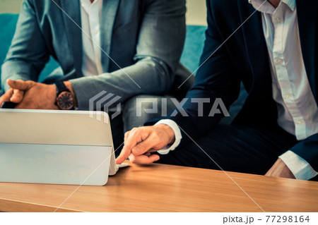Businessmen are in business meeting in office. 77298164